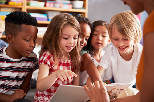 students looking at book